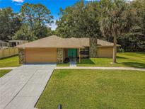 Charming single story home with stone accents and a teal front door at 4980 Sw 195Th Ave, Dunnellon, FL 34431