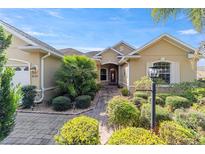 Beautiful house exterior with landscaping and a paved walkway at 8650 Sw 83Rd Loop, Ocala, FL 34481