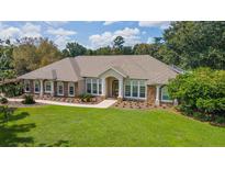 House exterior, landscaped lawn, and driveway visible from above at 8280 Se 15Th Ct, Ocala, FL 34480