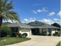 Single-Gathering home with a two-car garage and palm trees at 15235 Sw 14Th Avenue Rd, Ocala, FL 34473