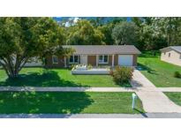 Single-story home with landscaped yard and attached garage at 14886 Sw 43Rd Terrace Rd, Ocala, FL 34473