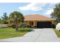 Single-story house with a two-car garage and landscaping at 2585 Sw 146Th St, Ocala, FL 34473