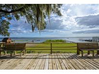 Wooden deck overlooking a lake with benches and beautiful views at 13414 Se 124Th Pl, Ocklawaha, FL 32179
