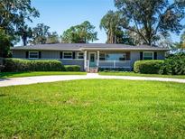 Charming ranch home with a circular driveway and manicured lawn at 1616 Se 12Th Ave, Ocala, FL 34471