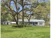 Ranch-style home with large yard and mature trees at 476 Nw 117Th Ct, Ocala, FL 34482