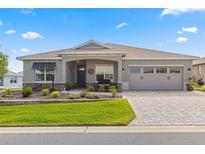Beautiful home with landscaping, paver driveway, and two-car garage at 9617 Sw 102Nd Ter, Ocala, FL 34481