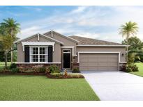 One-story home with stone accents, two-car garage, and manicured lawn at 4159 Nw 48Th Terrace Rd, Ocala, FL 34482