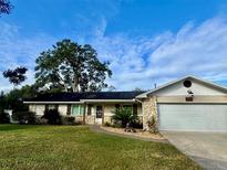 Ranch style home with stone accents and mature landscaping at 730 Ne 18Th Ave, Ocala, FL 34470