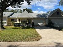 Cute two-bedroom villa with a well-maintained lawn at 9460 Sw 84Th Ter # E, Ocala, FL 34481