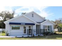 Single-story home with gray siding, black fence, and landscaping at 10478 Se 162Nd Place Rd, Summerfield, FL 34491