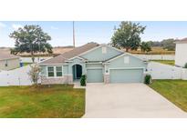 Aerial view of a light blue two-story house at 4710 Sw 65Th Pl, Ocala, FL 34474