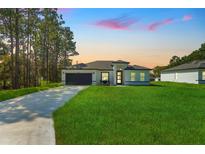 Modern house exterior with a driveway and lawn at 5984 Sw 128Th Street Rd, Ocala, FL 34473