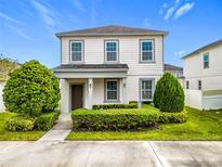 Two-story house with well-manicured landscaping at 6317 Hamlin Reserve Blvd, Winter Garden, FL 34787