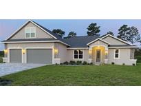 Two-story home with gray siding and stone accents at 17781 Sw 72Nd Street Rd, Dunnellon, FL 34432