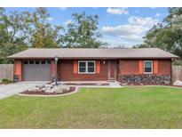 Charming ranch home with wood siding and landscaped yard at 1335 Ne 33Rd St, Ocala, FL 34479