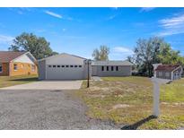 Newly renovated home with gray siding and a two-car garage at 6 Silver Trl, Ocala, FL 34472