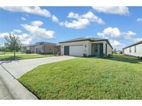 Single-story house with a garage and well-manicured lawn at 6119 Sw 93Rd Cir, Ocala, FL 34481
