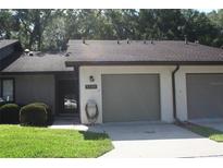 Front view of a townhouse with a two-car garage and well-maintained landscaping at 3706 Ne 16Th Pl, Ocala, FL 34470
