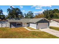 Gray house with white garage door and fenced yard at 3720 Ne 28Th Ter, Ocala, FL 34479