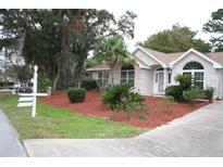 One-story home with landscaped yard and palm trees at 8473 Sw 108Th Place Rd, Ocala, FL 34481