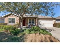 Single-story home with landscaped yard and two-car garage at 9350 Sw 91St Court Rd, Ocala, FL 34481