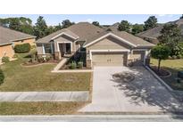 Single-Gathering home with two-car garage and landscaped yard at 9826 Sw 63Rd Loop, Ocala, FL 34481