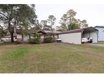 Ranch style home with carport, solar panels and spacious yard at 17411 Se 18Th St, Silver Springs, FL 34488