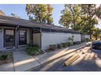 Exterior view of condo building with landscaping and parking at 3031 Se 5Th Ter # C, Ocala, FL 34471