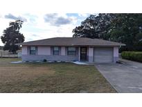 Cute ranch home with a one car garage and landscaped yard at 5500 Ne 11Th Ave, Ocala, FL 34479