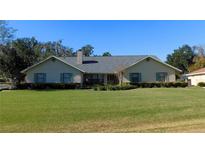 One-story home with green shutters and spacious lawn at 3282 Sw 9Th Ave, Ocala, FL 34471