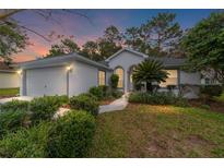 Inviting home exterior featuring a landscaped yard and attached garage at 11661 Sw 70Th Ct, Ocala, FL 34476