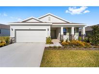 One-story home with light-colored siding, stone accents, and a two-car garage at 6071 Sw 93Rd Loop, Ocala, FL 34476