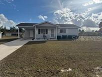 One-story home with gray siding, driveway, and small front yard at 8152 Sw 106Th St, Ocala, FL 34481