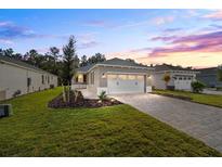 New construction home with two-car garage and landscaped yard at 10338 Sw 99Th Ln, Ocala, FL 34481