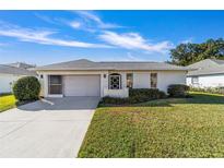 Single-story home with attached garage and well-manicured lawn at 6776 Sw 114Th Street Sw Rd, Ocala, FL 34476