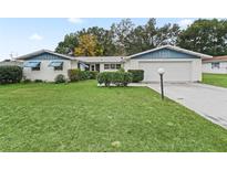 Charming single-story home with a well-manicured lawn and attached garage at 39 Emerald Dr, Ocala, FL 34472