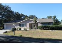 Single-story house with a two-car garage and landscaped lawn at 10918 Sw 82Nd Ter, Ocala, FL 34481