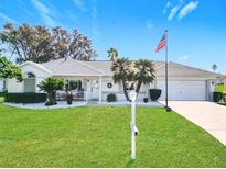 Single-story home with attractive landscaping and a two-car garage at 5226 Nw 21St Loop, Ocala, FL 34482