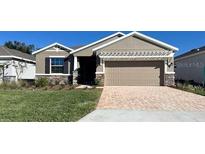 One-story home with a two-car garage and a landscaped lawn at 4098 Nw 48Th Terrace Rd, Ocala, FL 34482