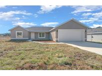 New construction home with a one-car garage and a large front yard at 281 Locust Pass, Ocala, FL 34472
