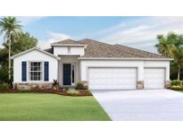 Charming single-story home with a three-car garage and landscaped front yard at 3092 Canopy Oak Blvd, Wildwood, FL 34785