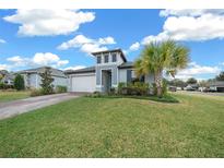 Inviting two-story home with a well-maintained lawn and palm trees at 3810 Se 4Th Ter, Ocala, FL 34480