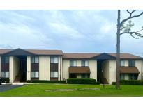 Two-story condo building with well-maintained landscaping and ample parking at 548 Fairways Dr # B, Ocala, FL 34472