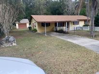Ranch-style house with carport and fenced yard at 1855 Ne 23Rd St, Ocala, FL 34470