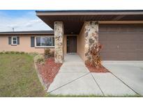 Inviting ranch home with stone accents and a two-car garage at 2201 Nw 135Th Ln, Citra, FL 32113