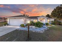 One-story house with attached garage, landscaped yard, and walkway at 7854 Sw 62Nd Ct, Ocala, FL 34476