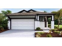 White house with dark trim, two-car garage, and landscaping at 4072 Nw 44Th Cir, Ocala, FL 34482