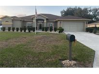 Single-story house with a well-maintained lawn and attached garage at 4420 Nw 6Th Cir, Ocala, FL 34475