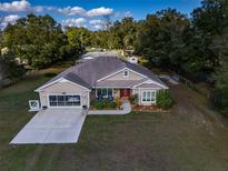 Single-story house with a large yard and two-car garage; an idyllic rural setting at 465 Ne 155Th Street Rd, Citra, FL 32113