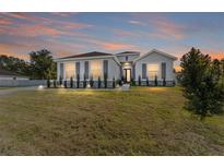 One-story home with gray siding, landscaping, and a lawn at 4812 Se 37Th St, Ocala, FL 34480